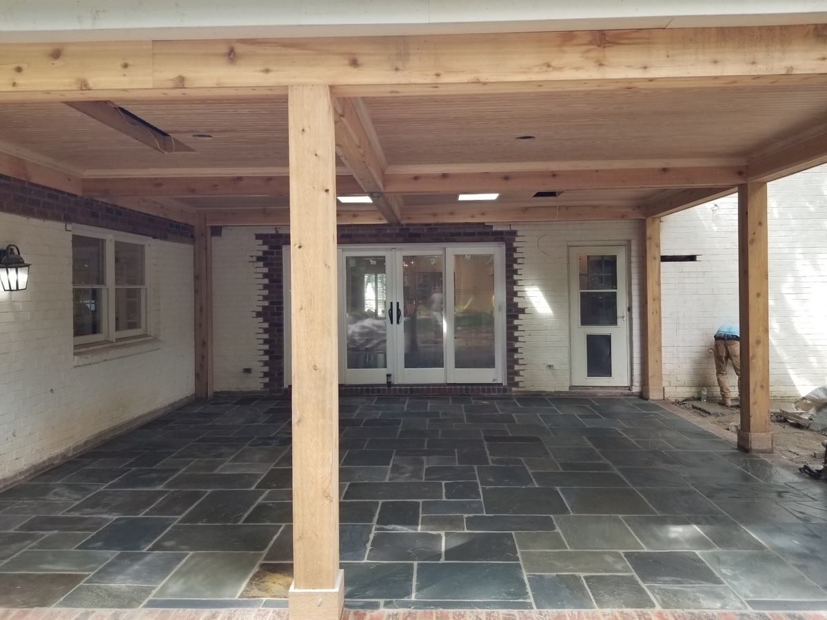 Bluestone patio under a new cedar-beam covered porch