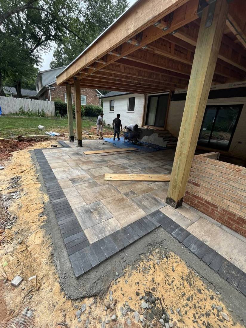Large-format pavers with charcoal border going in under a new covered porch