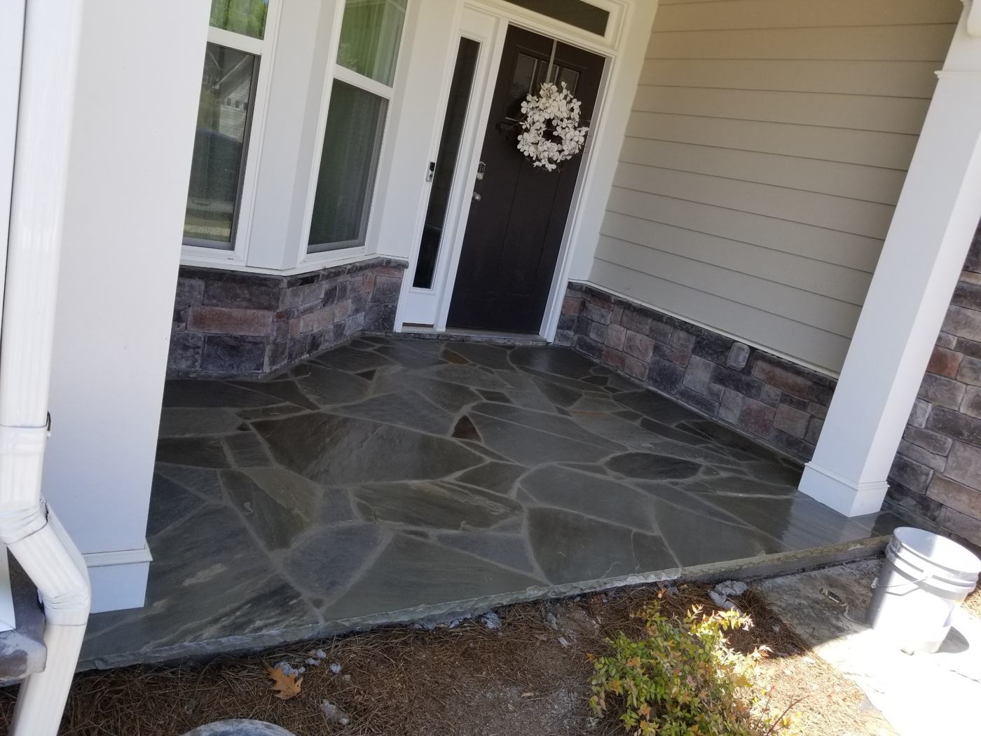 Flagstone front porch with stone veneer base