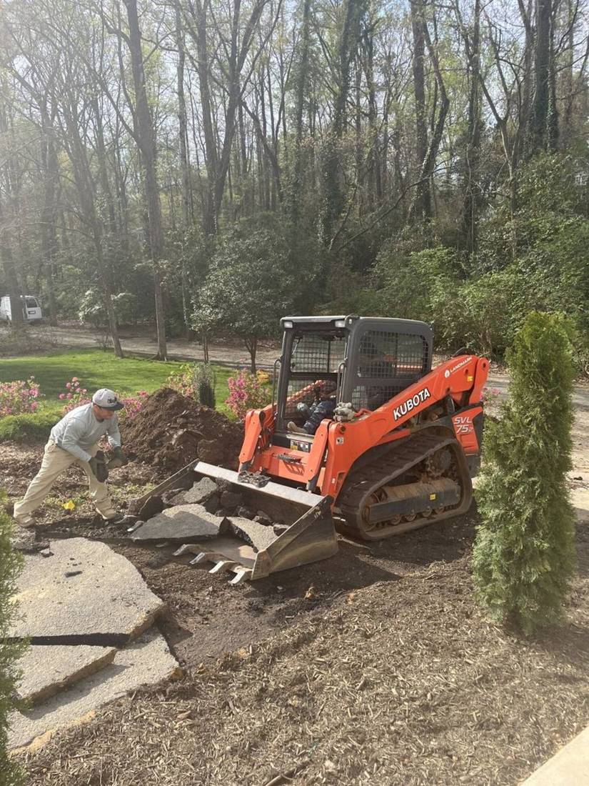 Crew and skid steer removing old flagstone