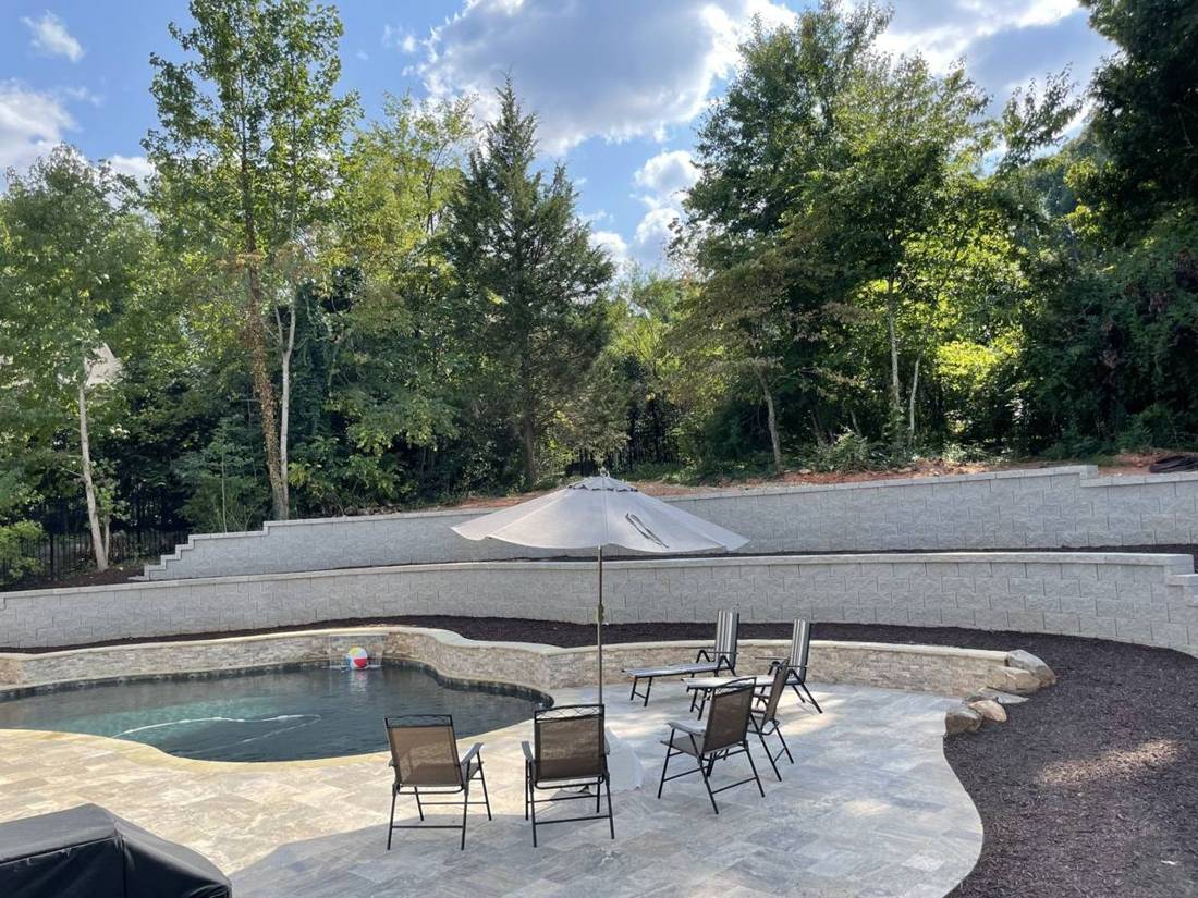 Pool deck with two terraced retaining walls behind it