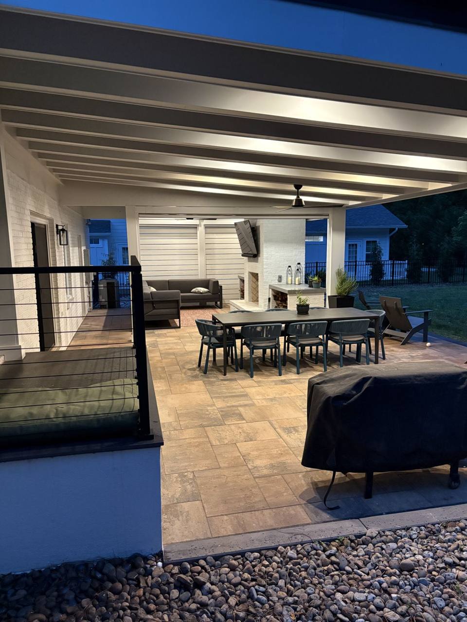 Covered porch dining area at dusk