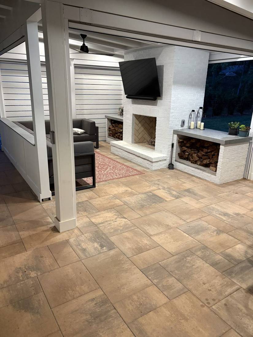 Covered porch with large-format pavers and fireplace