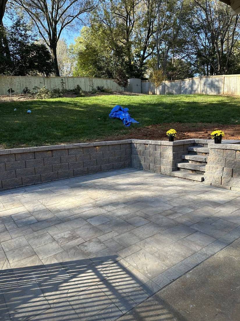 Paver patio with block retaining wall and built-in steps