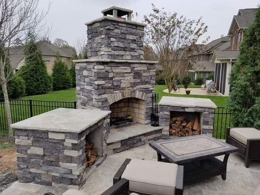 Front page hardscape fireplace with wood storage