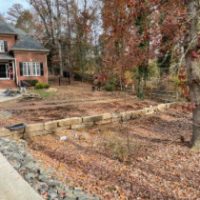 Boulder wall backfilled with drainage Landmark Advanced Outdoor solutions Charlotte NC