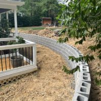 Drainage behind wall diverts watershed away from house