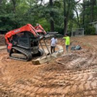 Installing boulder retaining wall at back of green